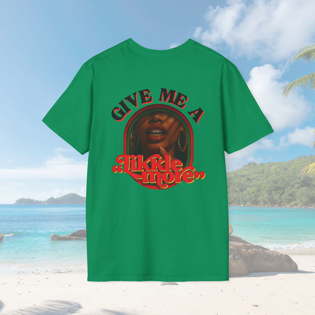 Bright green unisex t-shirt displayed on a tropical beach backdrop. The back features a bold red/yellow retro graphic of a Caribbean woman with the text “Give Me A Likkle More.” Palm trees and turquoise water in the background evoke vacation vibes.