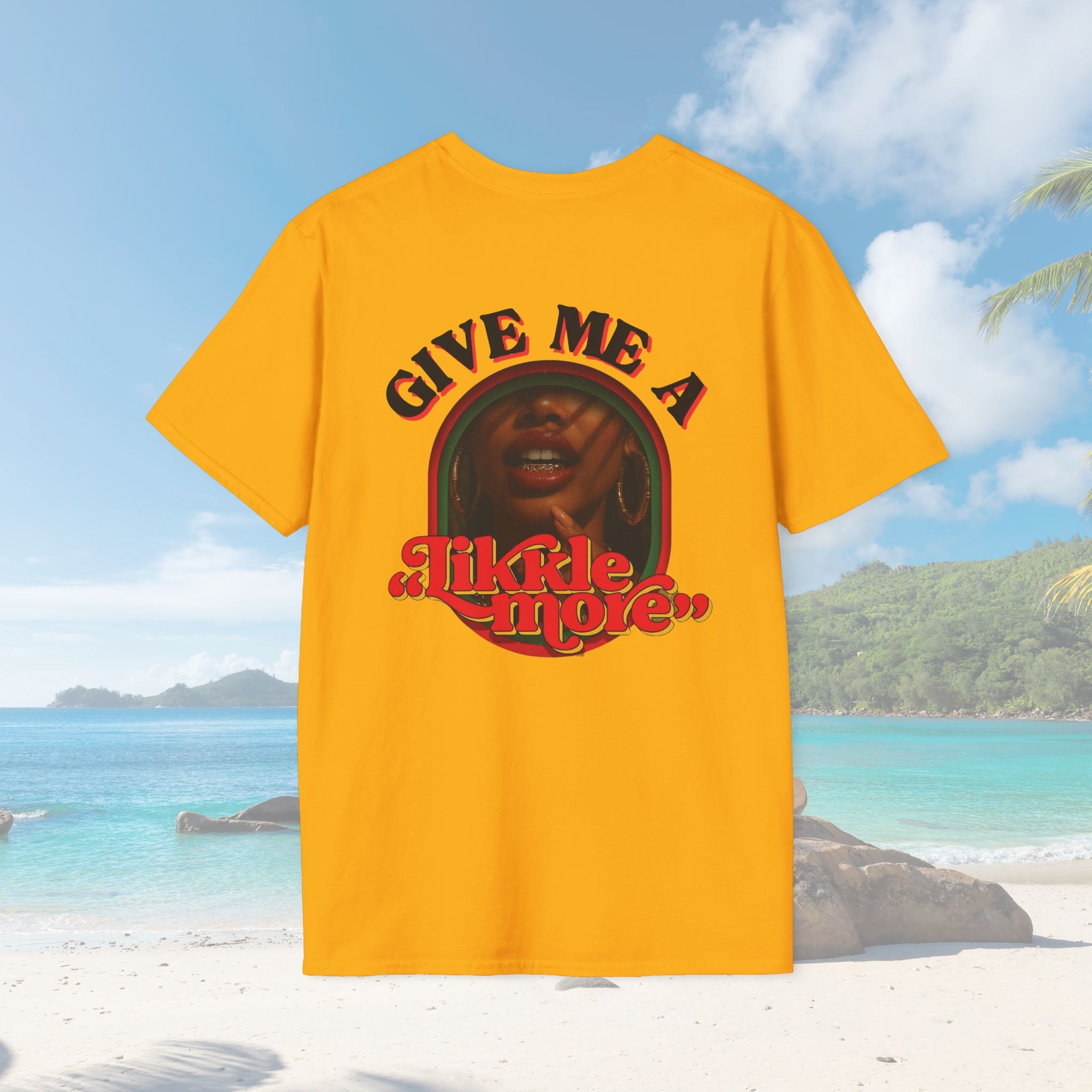 Mustard gold version of the same shirt, set against the same tropical beach. The graphic design stands out with strong contrast and vibrant cultural tones.
