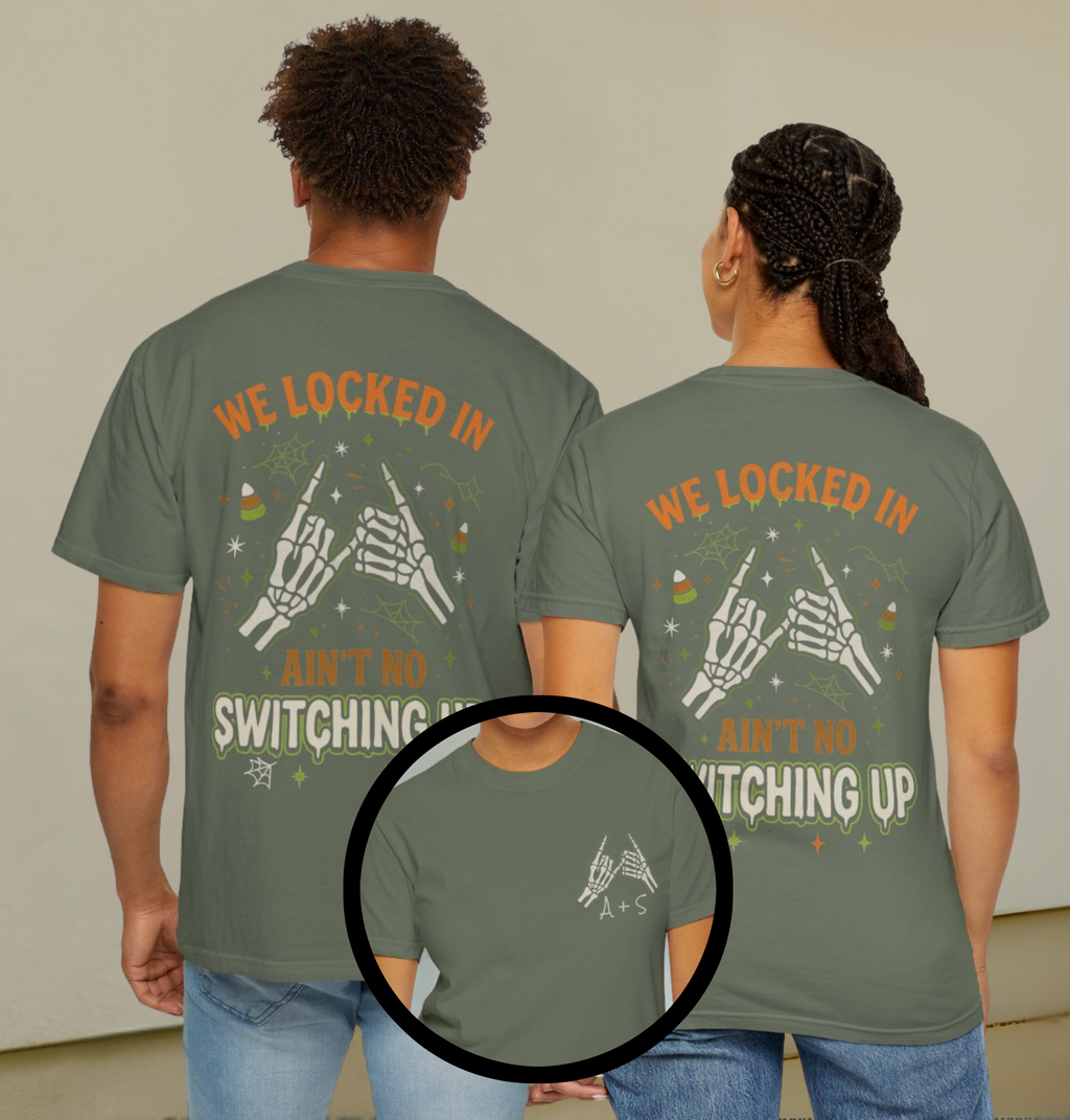 Two people wearing green t-shirts with text and graphics on the back.
