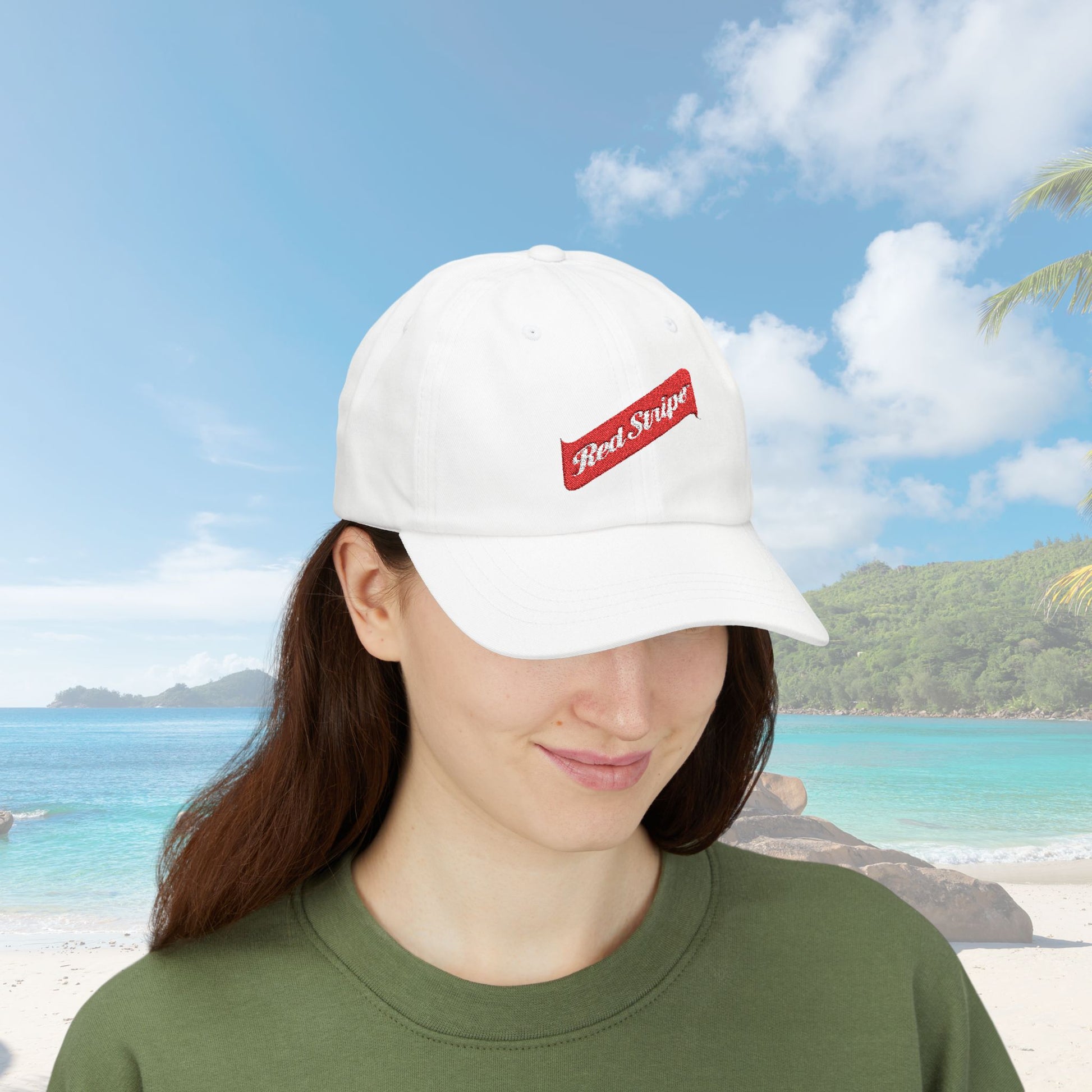 Jamaica Red Stripe Beer Logo Classic Dad Hat. The hat is a casual, curved-brim style with a structured front panel, featuring the Red Stripe Beer logo embroidered prominently in the center. The logo includes the signature red diagonal stripe and text, symbolizing the authentic Jamaican beer brand. The hat comes in a classic yet relaxed vibe, making it an ideal gift for beer enthusiasts, fathers, or anyone celebrating Jamaican heritage.