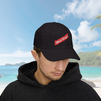 Jamaica Red Stripe Beer Logo Classic Dad Hat. The hat is a casual, curved-brim style with a structured front panel, featuring the Red Stripe Beer logo embroidered prominently in the center. The logo includes the signature red diagonal stripe and text, symbolizing the authentic Jamaican beer brand. The hat comes in a classic yet relaxed vibe, making it an ideal gift for beer enthusiasts, fathers, or anyone celebrating Jamaican heritage.