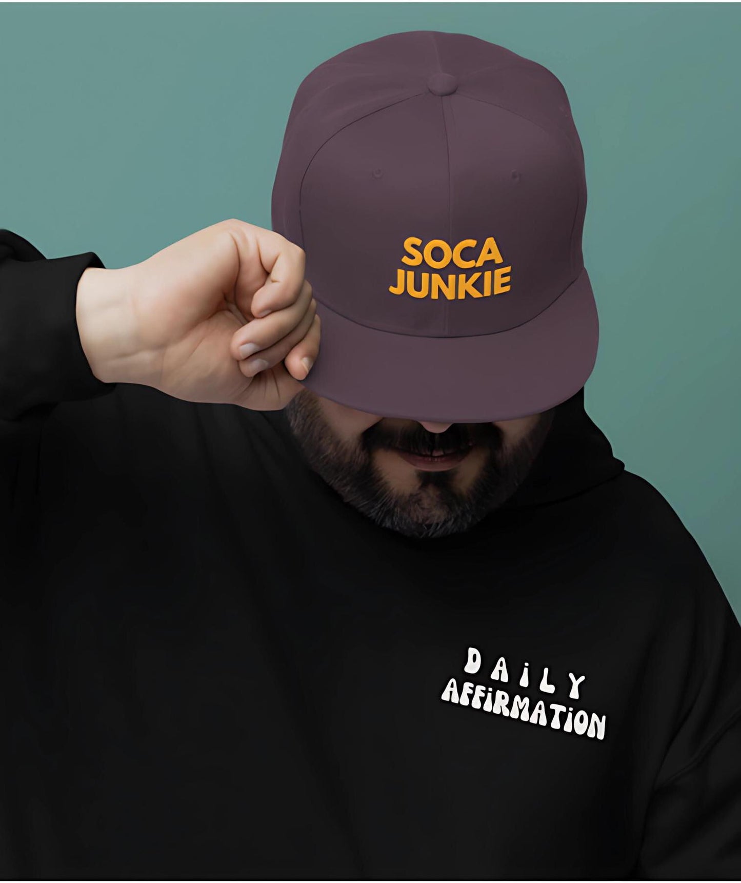 A sleek black snapback hat with &quot;Soca Junkie&quot; embroidered in bold, vibrant lettering on the front. This stylish cap is perfect for carnival fetes, music festivals, or everyday wear, celebrating Caribbean culture and Trinidad & Tobago vibes.