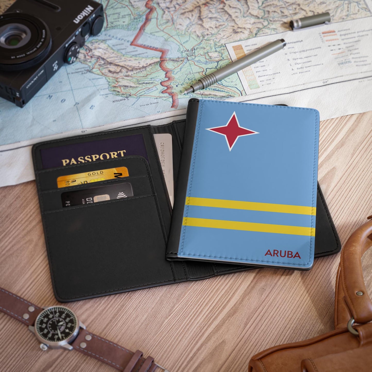 A sleek faux leather passport cover featuring the vibrant flag Aruba, with the country&#39;s name displayed in a stylish font. This travel accessory offers RFID-blocking protection and compartments for cards and boarding passes.