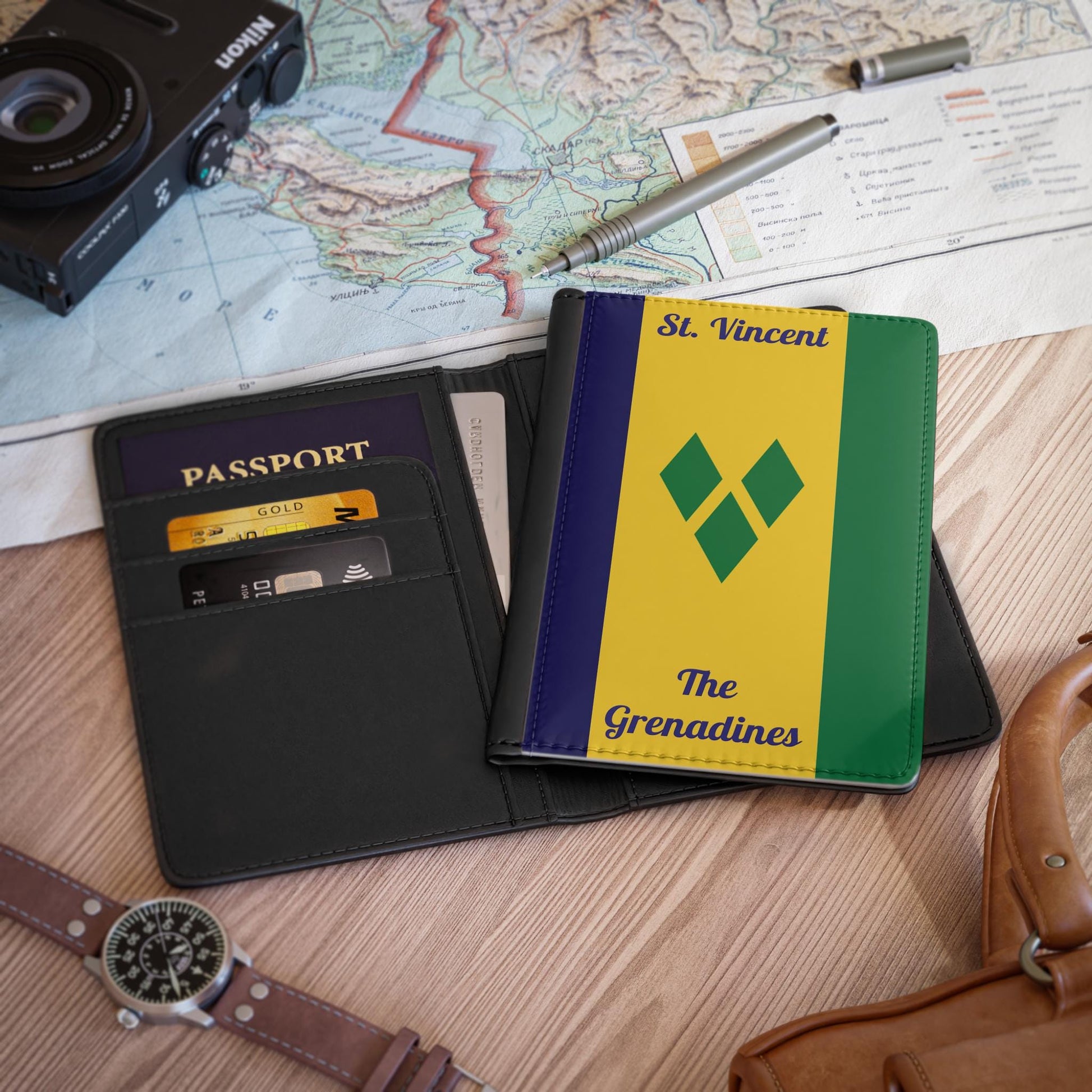 A sleek faux leather passport cover featuring the vibrant flag of St. Vincent & The Grenadines, with the country name displayed in a stylish font. This travel accessory offers RFID-blocking protection and compartments for cards and boarding passes.