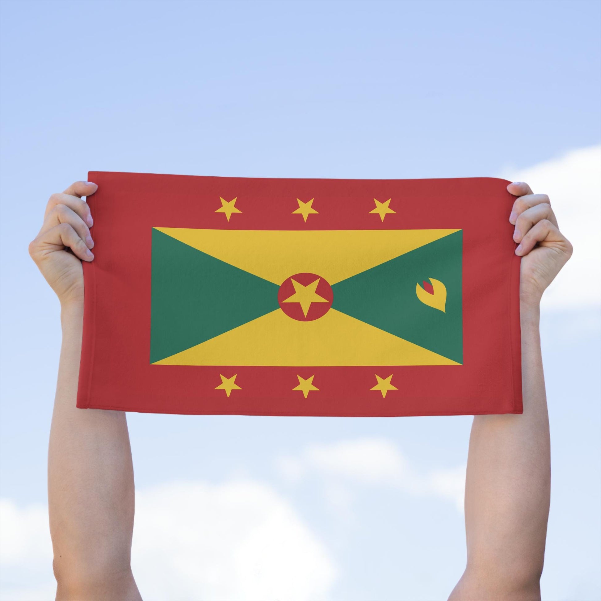 Grenada Flag Towel: Flag with a red background and a yellow, green pattern. A central red circle with a yellow star, surrounded by six yellow stars. Vibrant and bold Grenadian Rag for carnivals, fetes, and parties.