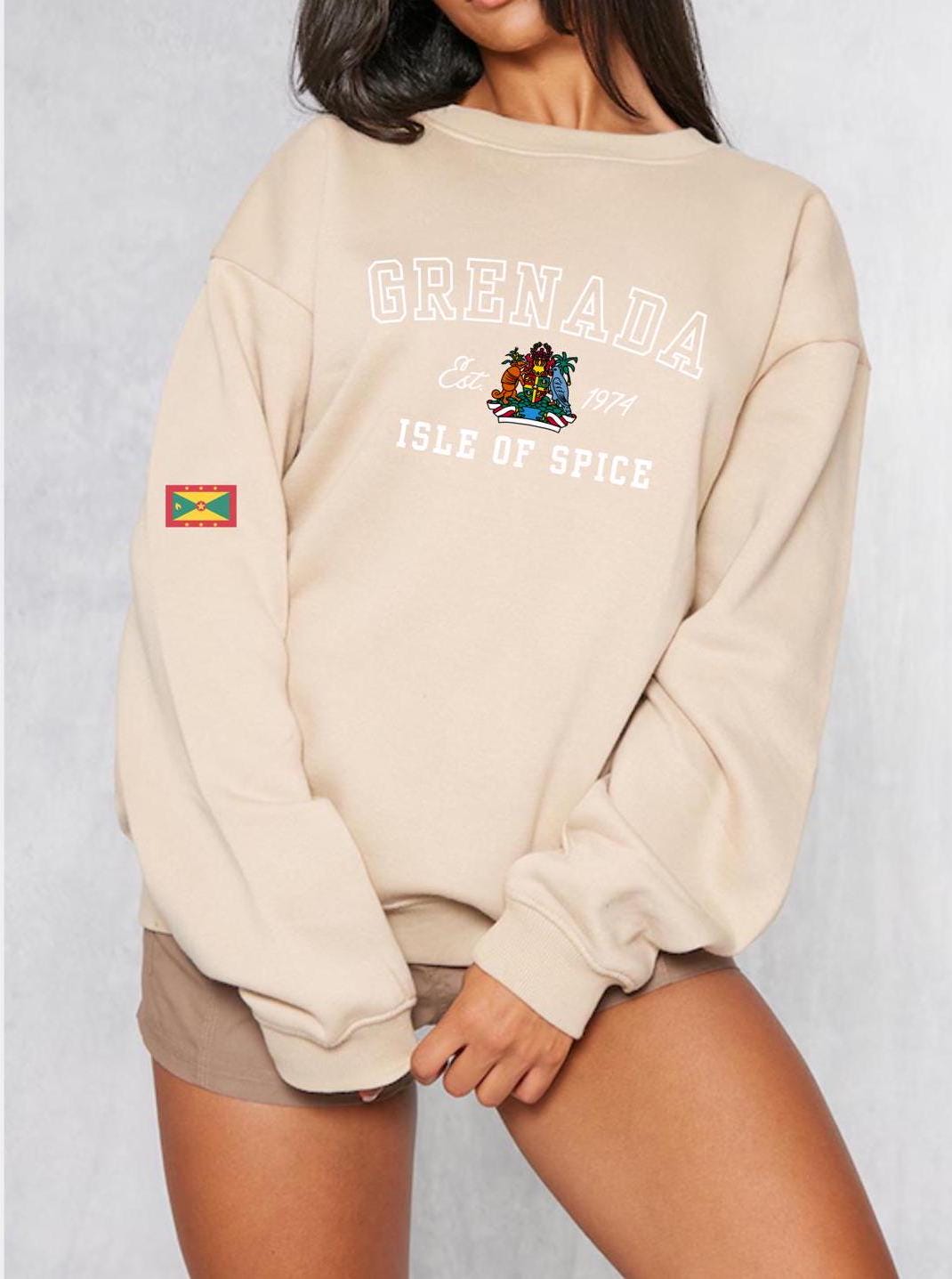 Grenada-inspired varsity sweatshirt featuring the Grenada flag graphic, the island’s independence year, and the Coat of Arms. This stylish sweatshirt showcases bold colors and a design celebrating Grenada’s rich heritage.