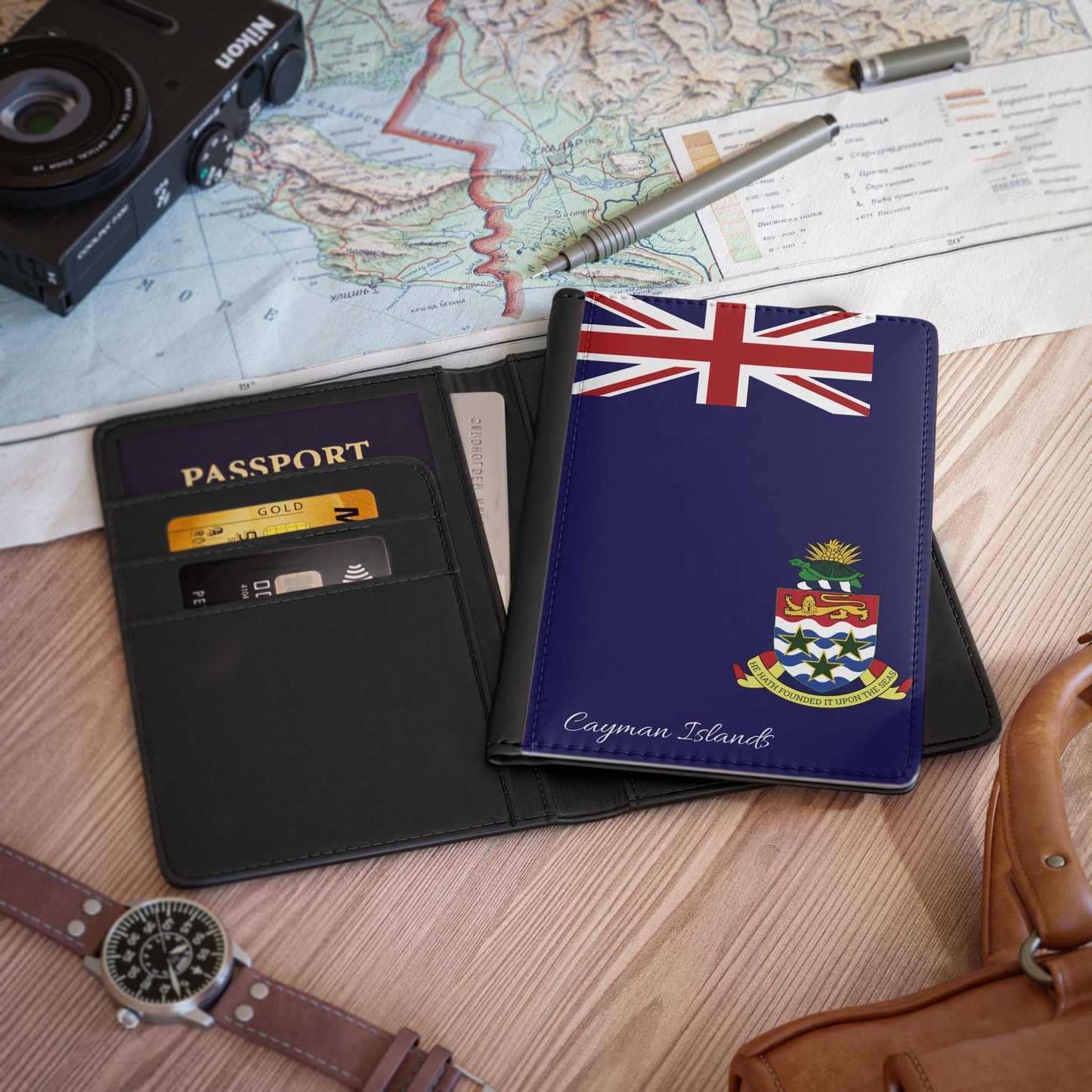 A sleek faux leather passport cover featuring the vibrant flag of the Cayman Islands, with the country&#39;s name displayed in a stylish font. This travel accessory offers RFID-blocking protection and compartments for cards and boarding passes.