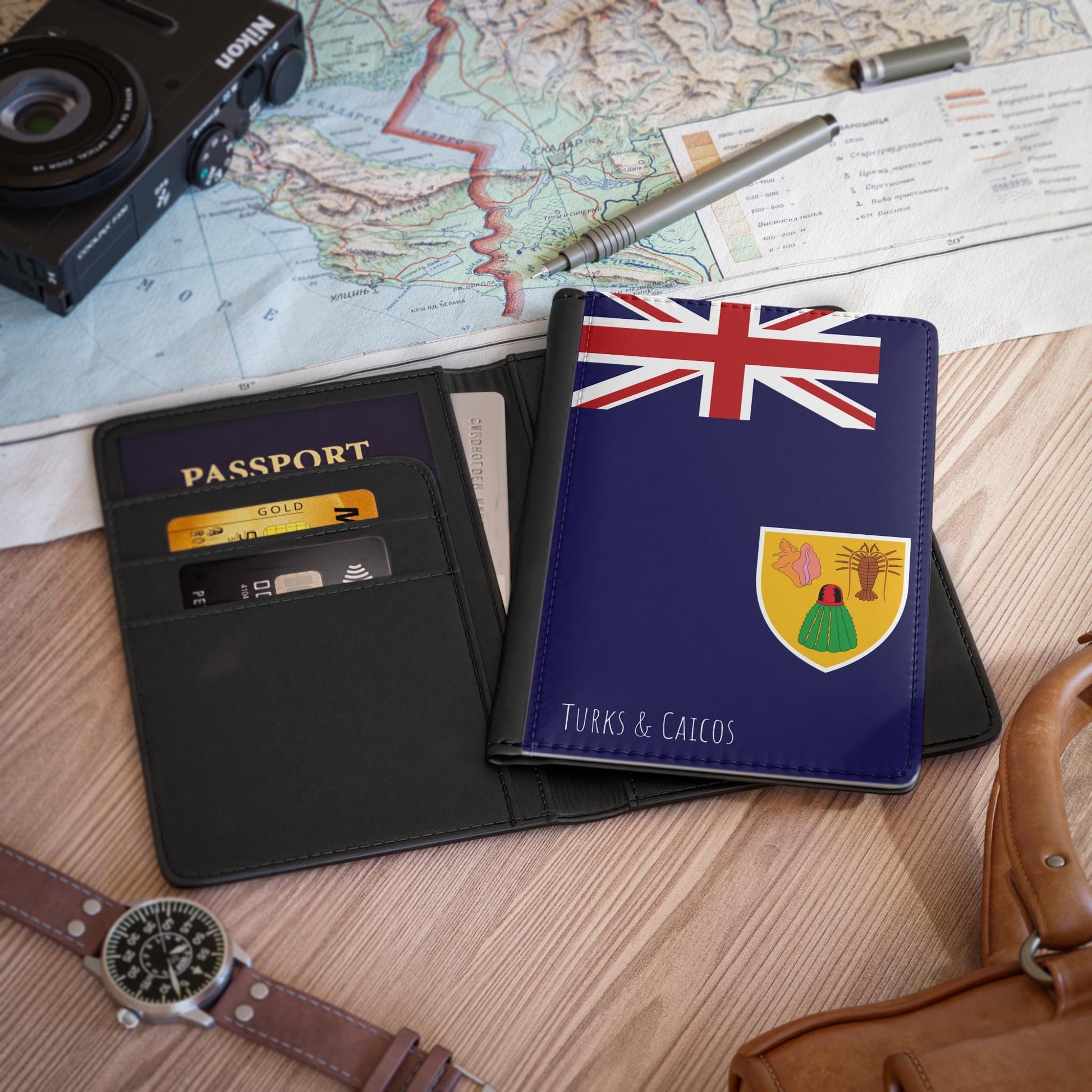 A sleek faux leather passport cover featuring the vibrant flag Turks & Caicos, with the country&#39;s name displayed in a stylish font. This travel accessory offers RFID-blocking protection and compartments for cards and boarding passes.