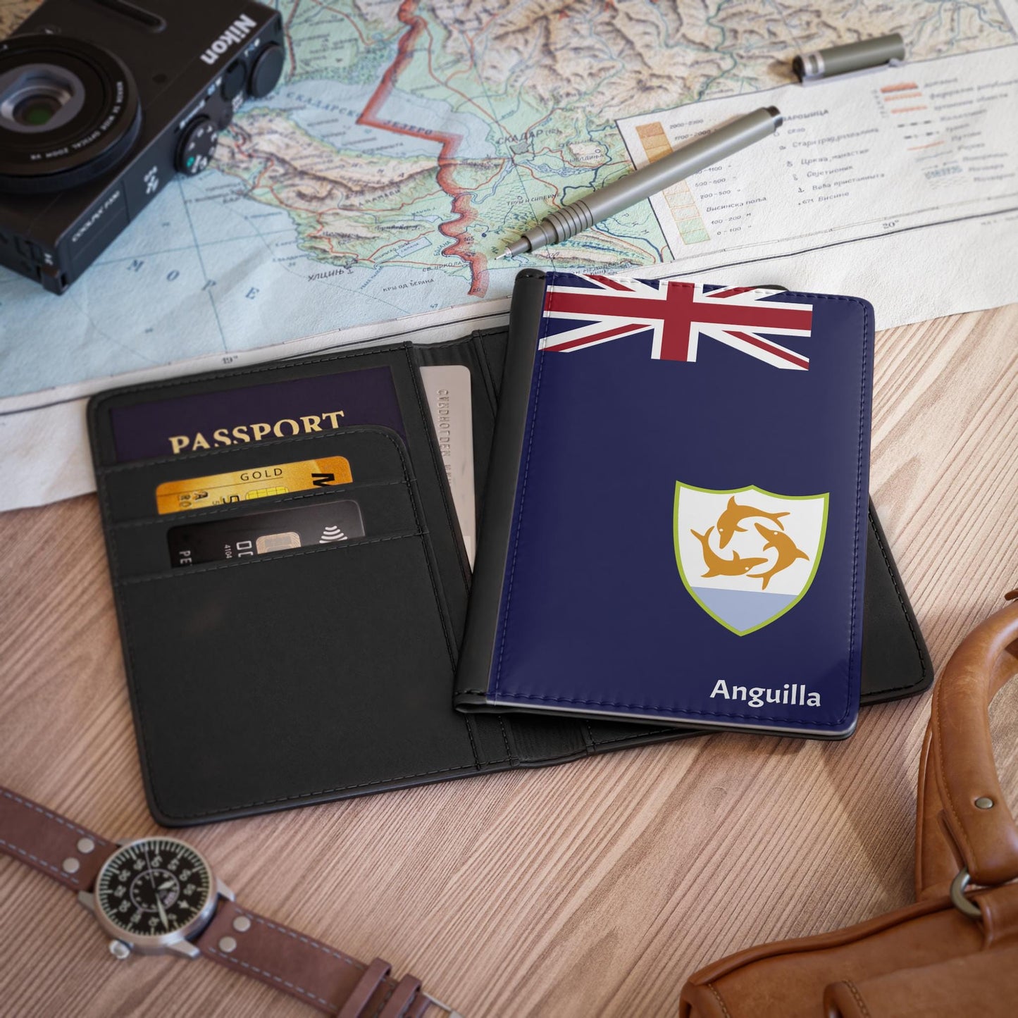 A sleek faux leather passport cover featuring the vibrant flag of Anguilla, with the country&#39;s name displayed in a stylish font. This travel accessory offers RFID-blocking protection and compartments for cards and boarding passes.