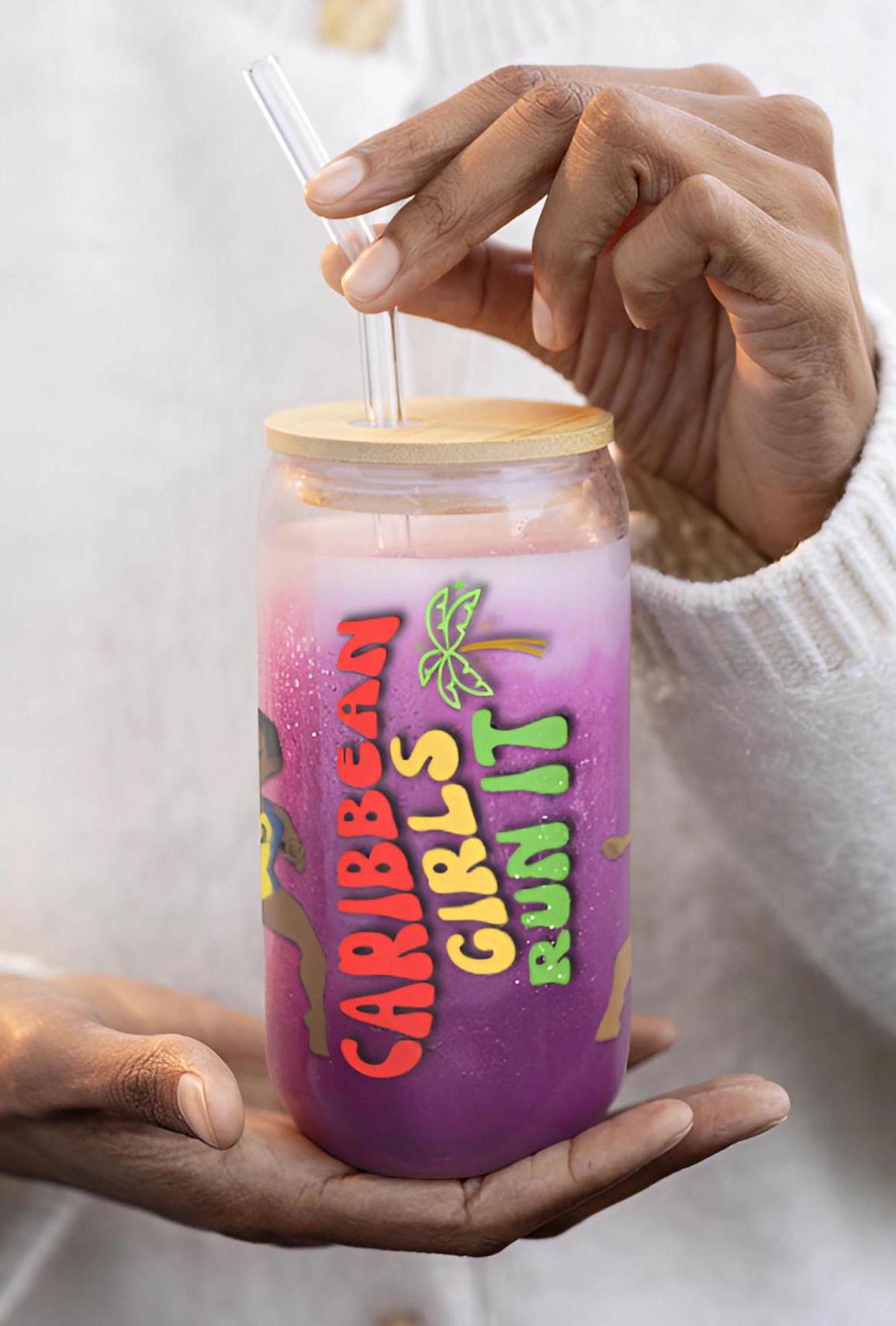 A Caribbean Island Girls Sipper Glass featuring cartoon illustrations of Caribbean island girls. This 16oz tropical drinkware is perfect for juices at Caribbean-themed parties. Designed with bold, playful details the phrase Caribbean Girls Run It.